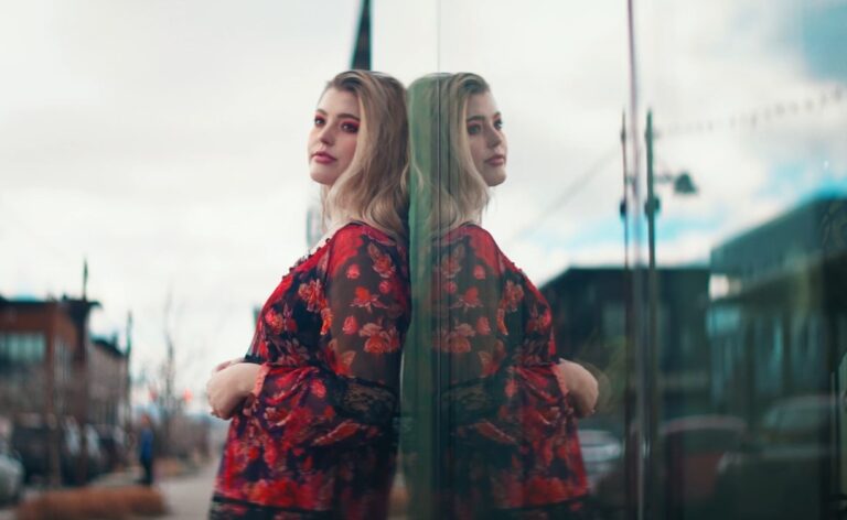 girls reflection on streets building