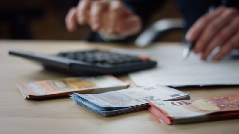 A bank clerk counting money for a loan