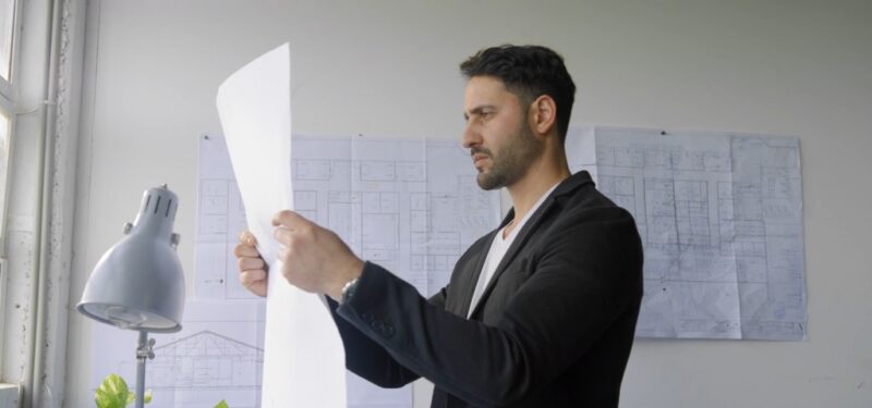 Manager analyzing business workflows to identify process bottlenecks and improve efficiency